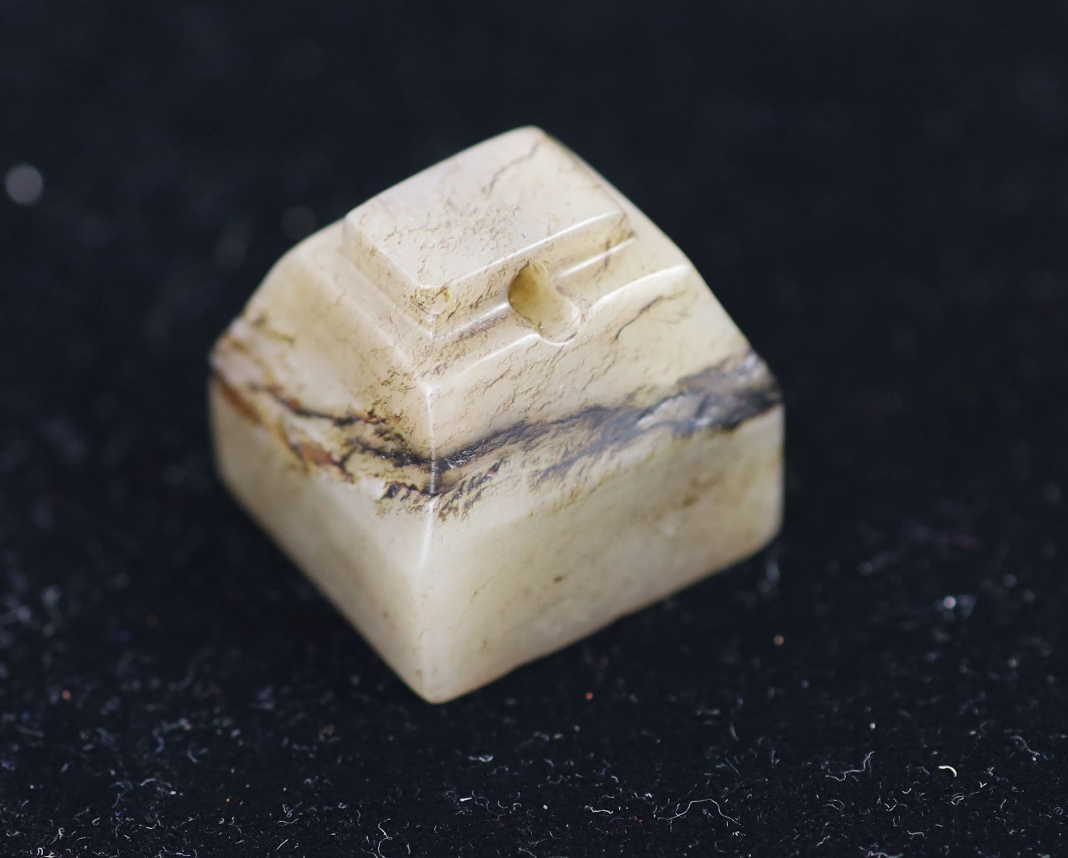 A Chinese grey and black jade square seal, 2.7cm